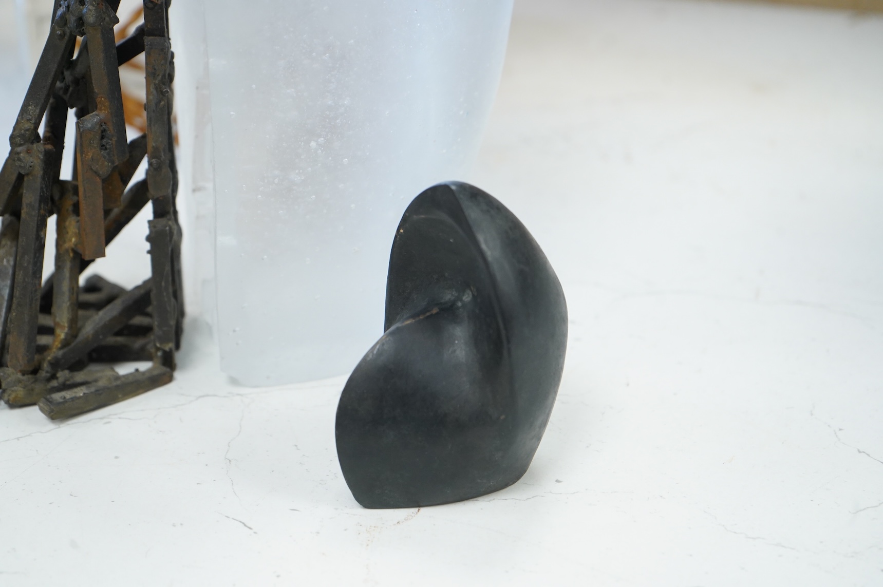 A contemporary Brutalist style glass and iron sculpture and two bronzes signed 'VA', 27cm